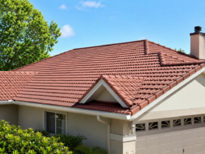 Close-up of a freshly cleaned terracotta tiled roof in Sutherland Shire NSW, showing neat roof ridges, clear gutters, cream exterior walls and surrounding garden greenery under a bright blue sky.